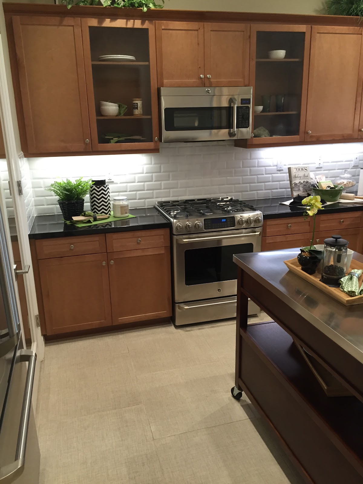 Kitchen with tile floor and subway-tile backsplash by Kosty's Flooring