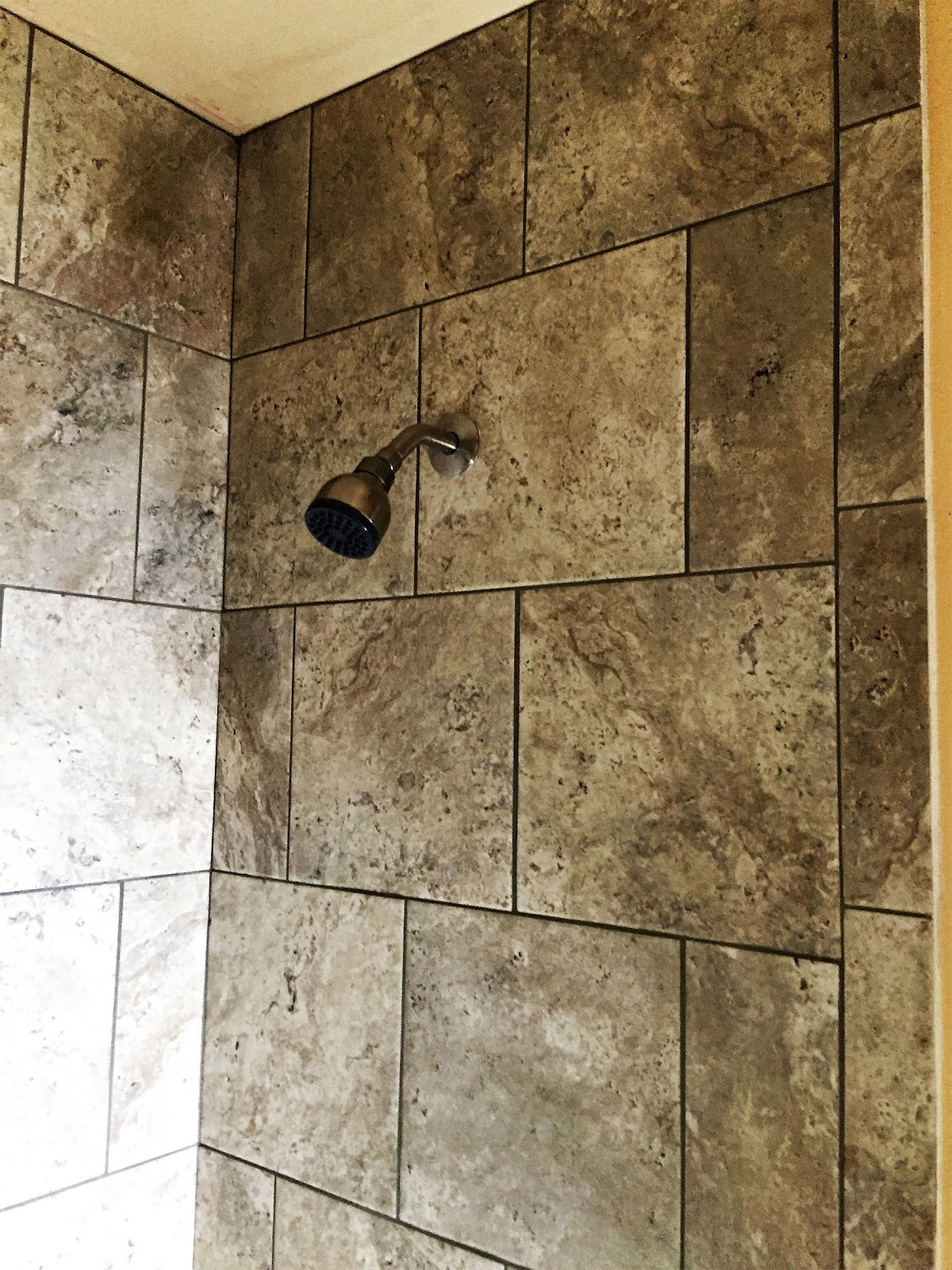 Tiled shower surround with offset stone tile